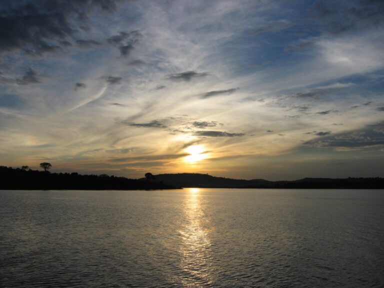 Sunset over Lake Victoria, Uganda, with the sun reflecting on calm water